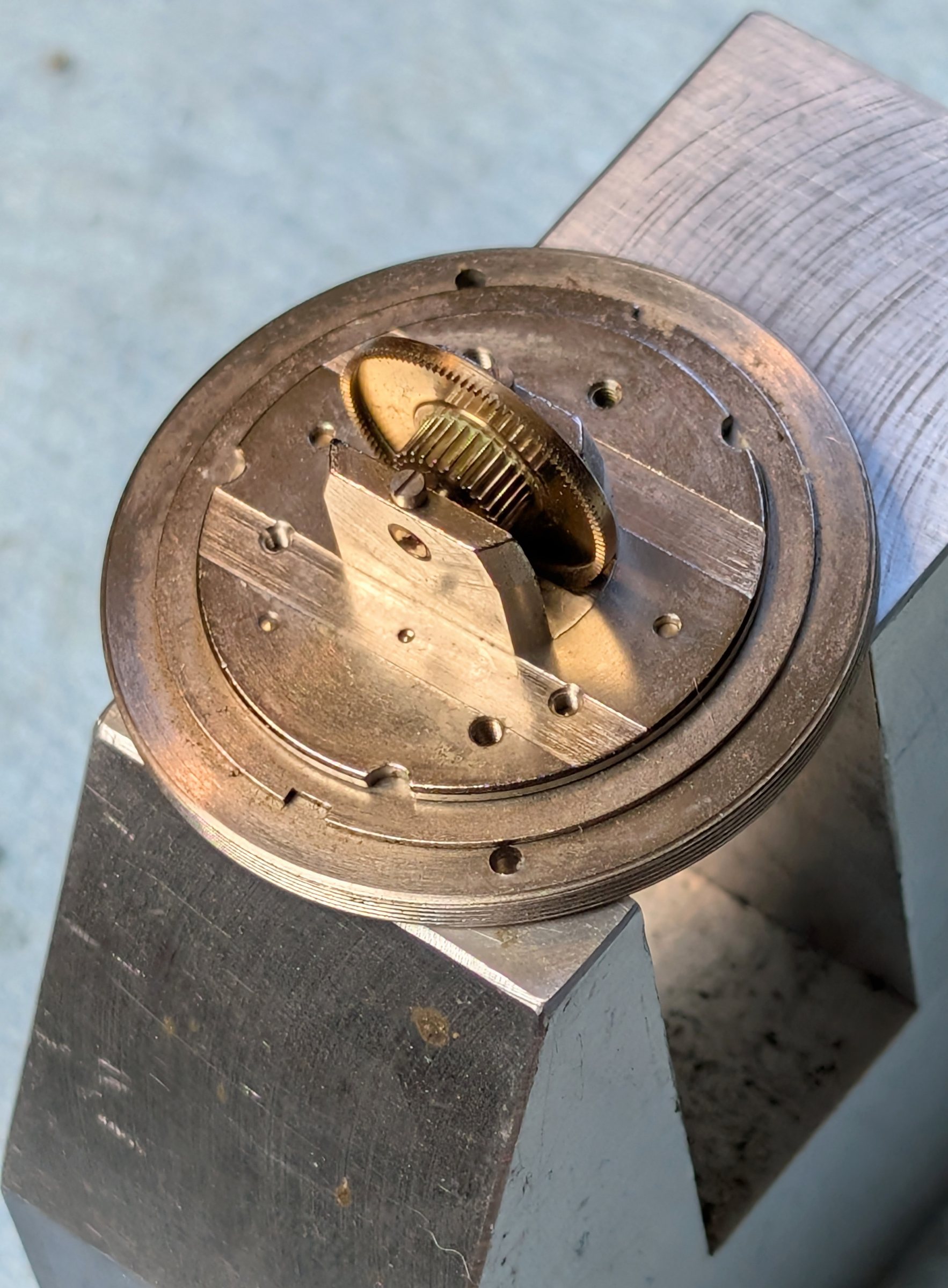 Crown gear on carrier plate, raking light showing peripheral and face tooth sets
